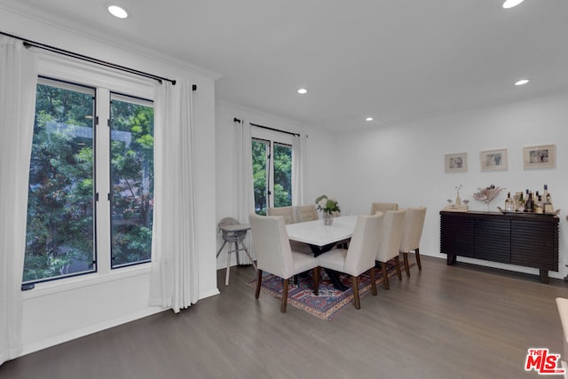 dining space featuring ornamental molding and dark hardwood / wood-style flooring