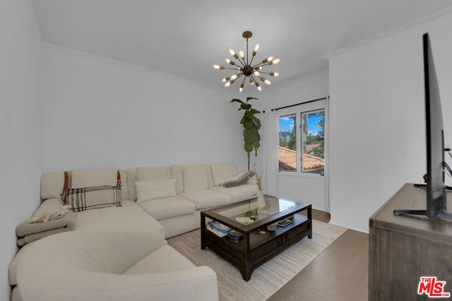 living room featuring crown molding, a chandelier, and light hardwood / wood-style flooring