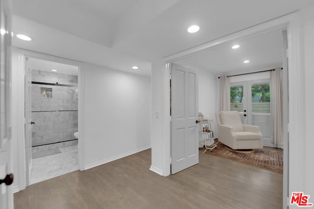 unfurnished room with wood-type flooring and french doors