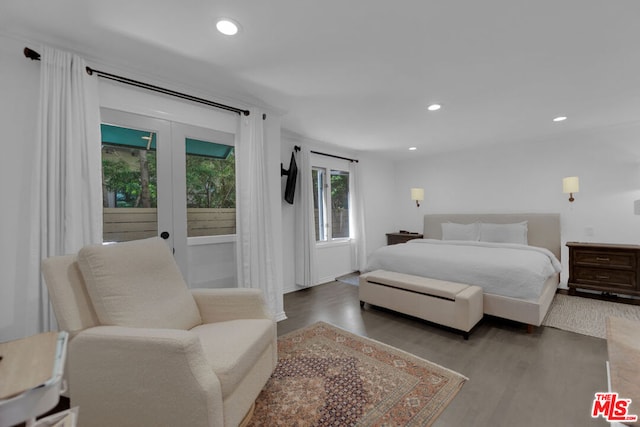 bedroom with french doors and wood-type flooring