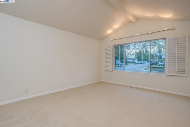 unfurnished room with lofted ceiling with beams and carpet