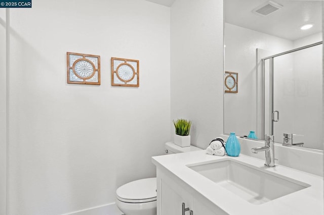 bathroom with vanity, toilet, and an enclosed shower