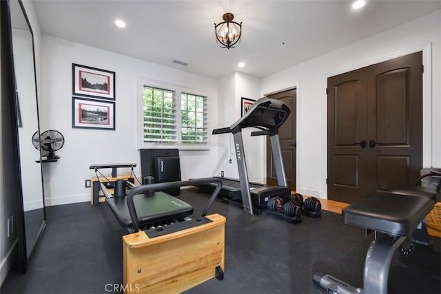 workout room with a notable chandelier