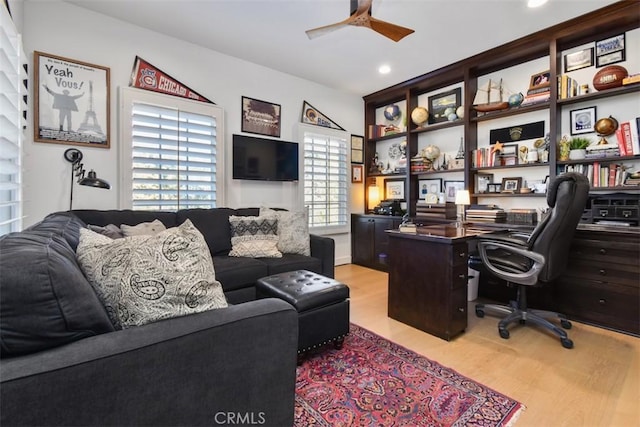 office space featuring ceiling fan and light hardwood / wood-style flooring