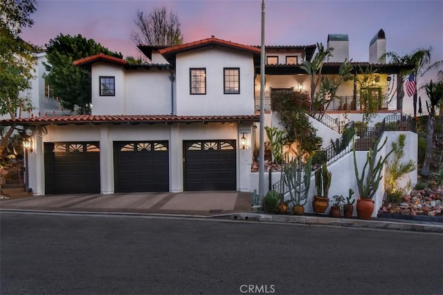 mediterranean / spanish-style house with a garage