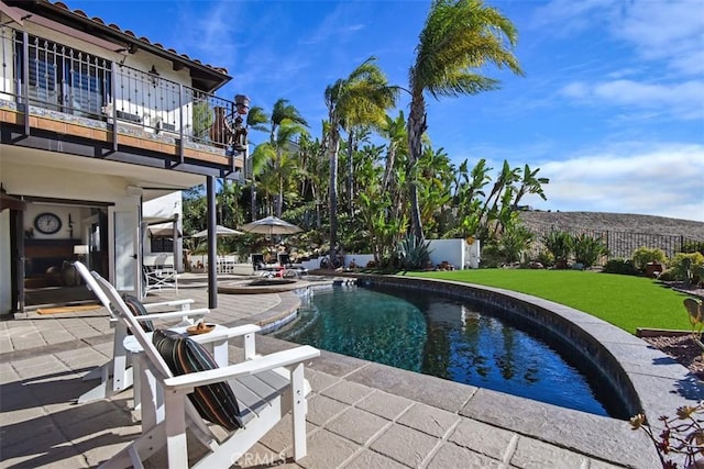 view of pool featuring a patio and a lawn