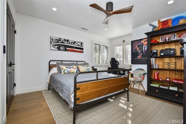 bedroom with hardwood / wood-style flooring and ceiling fan