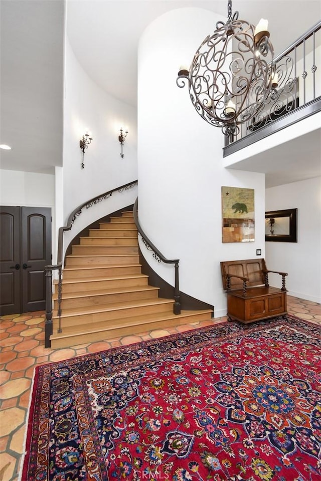 stairway featuring a chandelier and a high ceiling