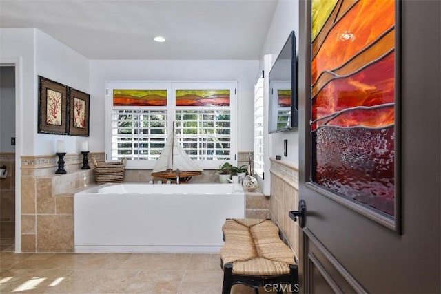 living area with light tile patterned flooring and tile walls