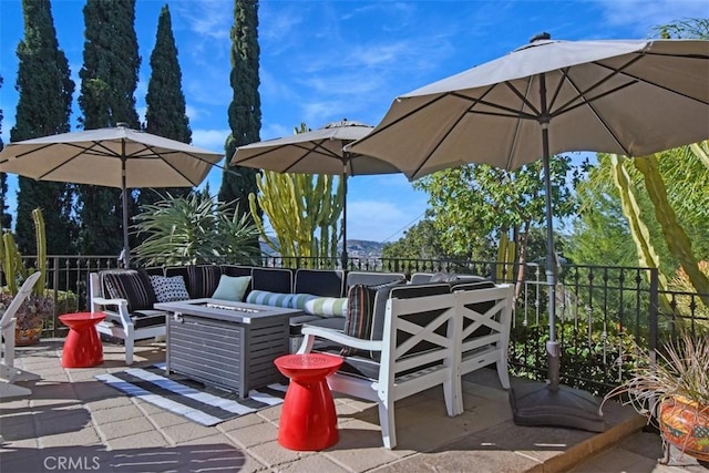 view of patio / terrace with an outdoor living space with a fire pit