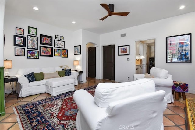 tiled living room with ceiling fan