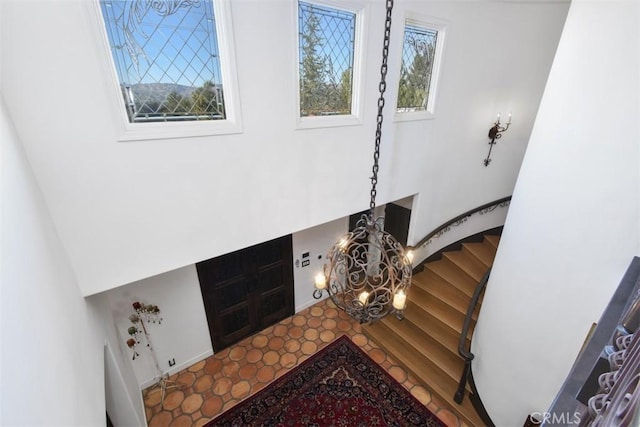 entryway with a chandelier