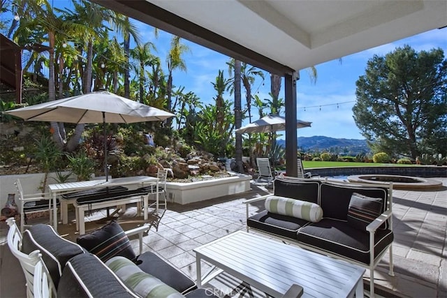 view of patio with an outdoor hangout area and a mountain view