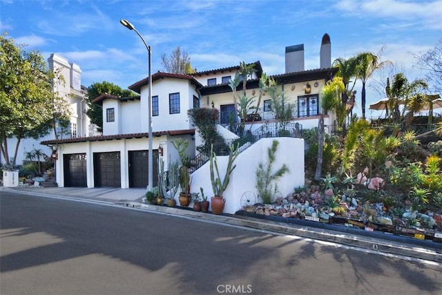 mediterranean / spanish home with a garage