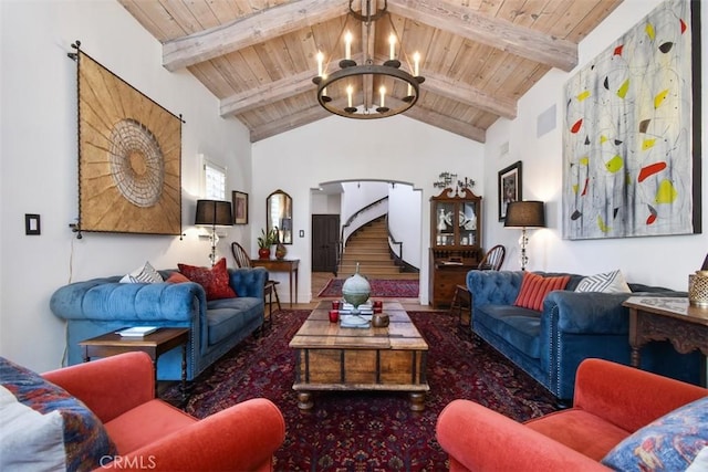 living room with beamed ceiling, high vaulted ceiling, wood ceiling, and an inviting chandelier