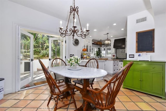 tiled dining area with a notable chandelier