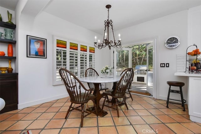 tiled dining space with a chandelier