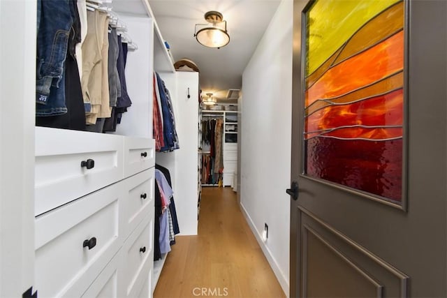 spacious closet featuring light hardwood / wood-style flooring