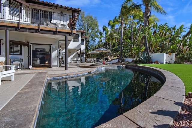 view of swimming pool with a yard and a patio area