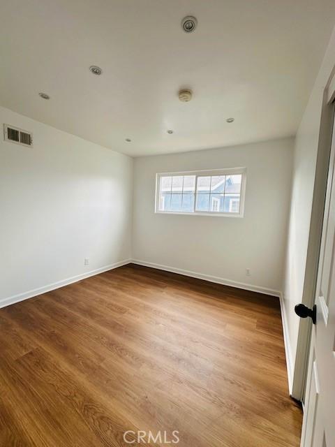 unfurnished room with hardwood / wood-style floors