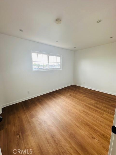 spare room with hardwood / wood-style floors