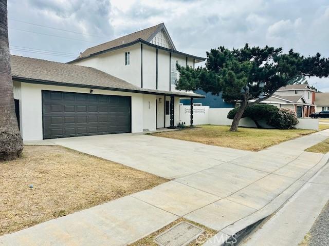 view of front of house with a garage and a front yard