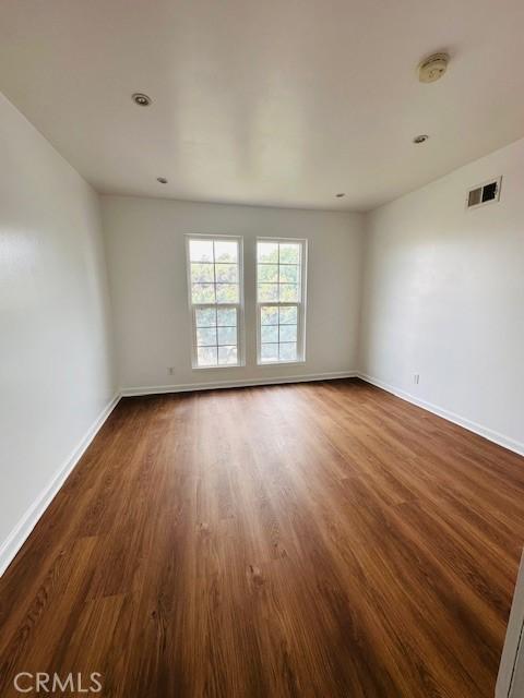 unfurnished room featuring dark hardwood / wood-style flooring