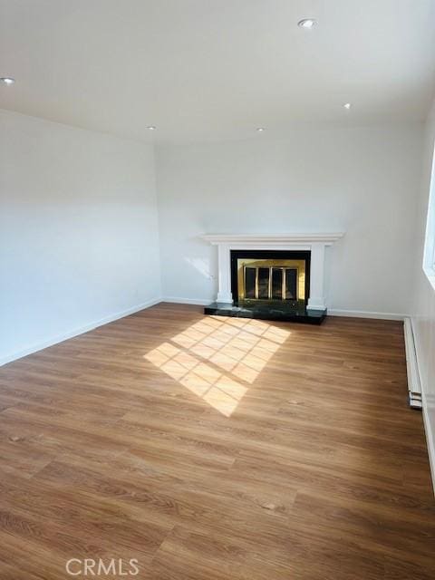 unfurnished living room with hardwood / wood-style flooring