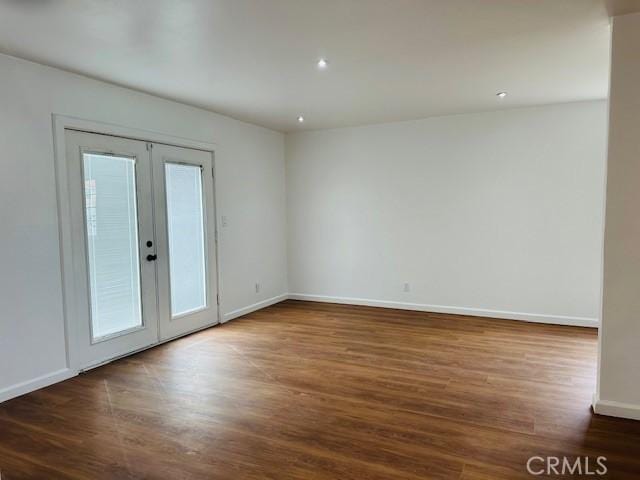 unfurnished room with french doors, dark hardwood / wood-style floors, and a wealth of natural light