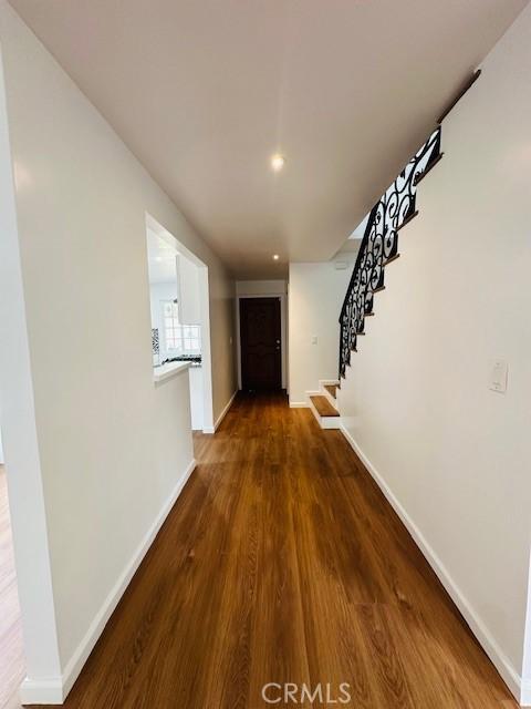 hall with dark hardwood / wood-style floors