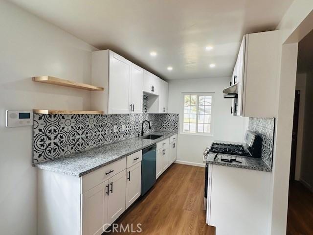 kitchen with white cabinetry, appliances with stainless steel finishes, dark wood-type flooring, and light stone counters