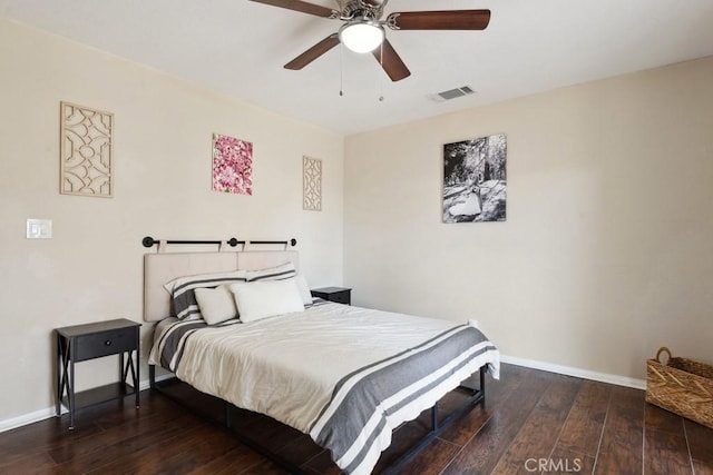 bedroom with dark hardwood / wood-style flooring and ceiling fan