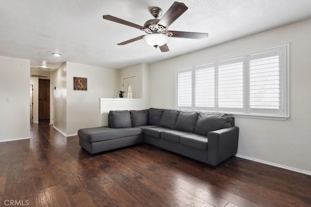 unfurnished living room with dark hardwood / wood-style floors and ceiling fan