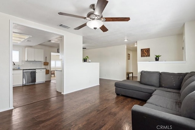 living room featuring dark hardwood / wood-style floors and ceiling fan