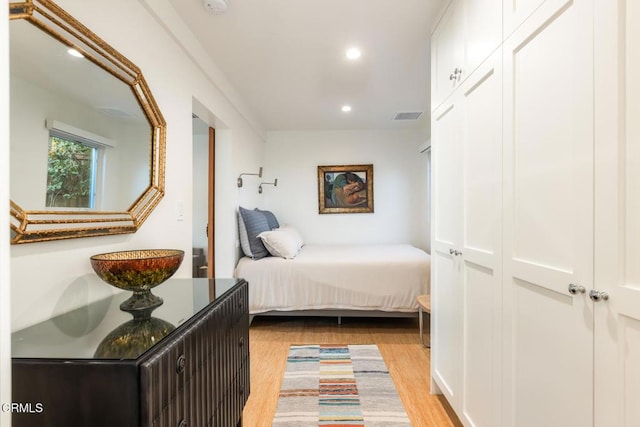 bedroom featuring light hardwood / wood-style flooring and a closet