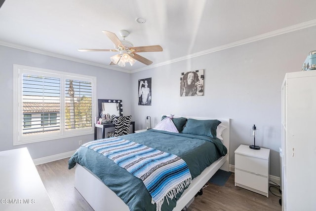 bedroom featuring ceiling fan, wood-type flooring, and ornamental molding