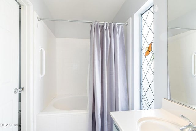 bathroom featuring vanity and shower / bathtub combination with curtain