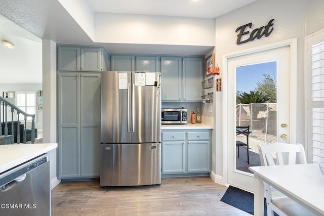 kitchen with stainless steel appliances and light hardwood / wood-style flooring