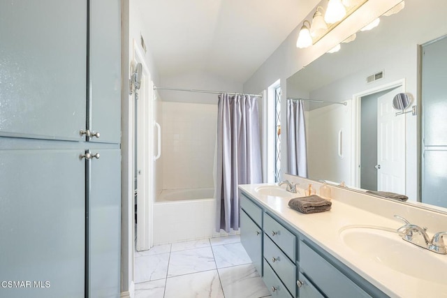 bathroom featuring lofted ceiling, vanity, and shower / bath combo