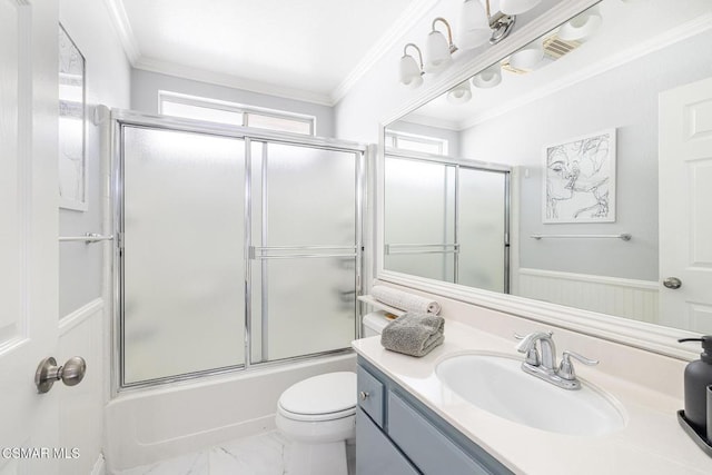 full bathroom featuring toilet, ornamental molding, vanity, and shower / bath combination with glass door