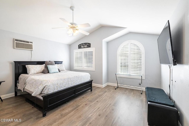 bedroom with hardwood / wood-style flooring, ceiling fan, a wall mounted air conditioner, and lofted ceiling