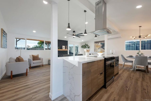 kitchen with island range hood, decorative light fixtures, light wood-type flooring, electric range, and ceiling fan with notable chandelier