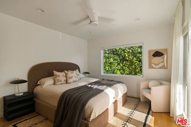 bedroom with light hardwood / wood-style flooring and ceiling fan