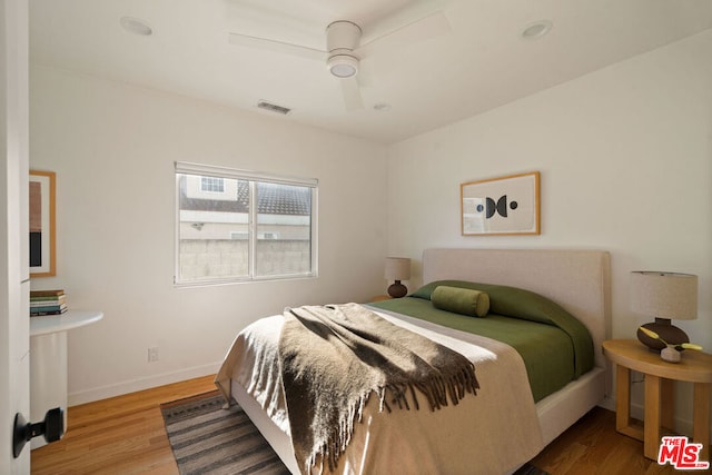 bedroom with hardwood / wood-style flooring and ceiling fan