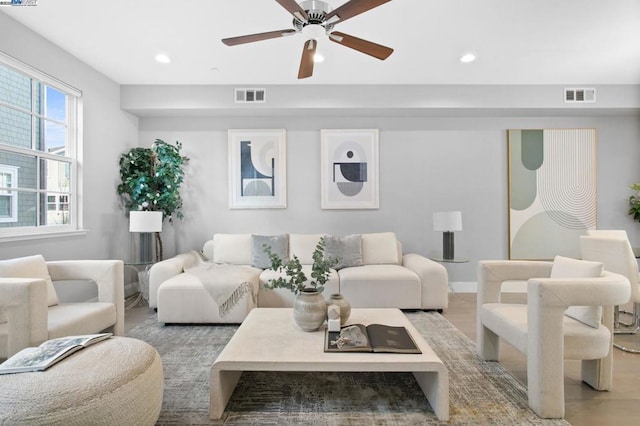 living room featuring light hardwood / wood-style floors and ceiling fan