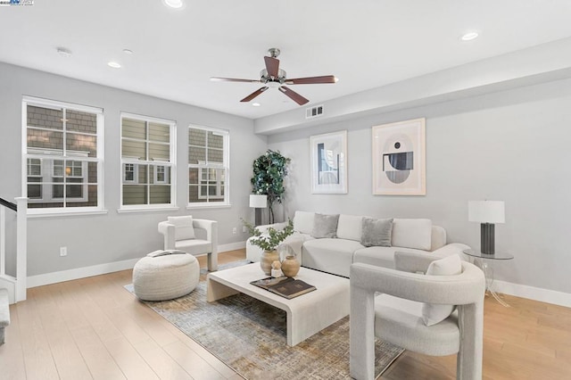 living room featuring ceiling fan and light hardwood / wood-style floors