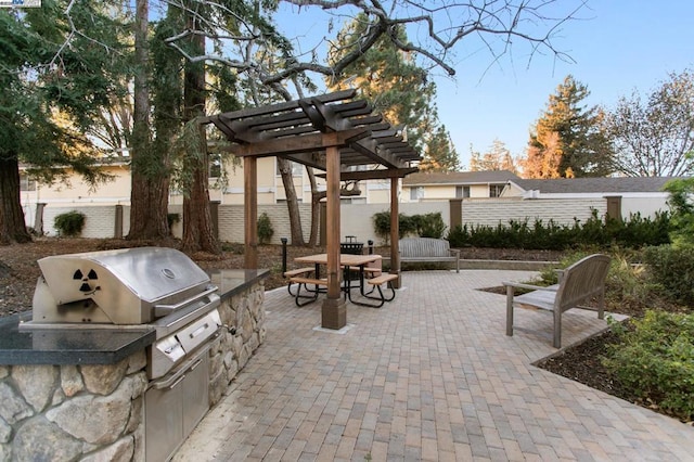 view of patio / terrace with an outdoor kitchen, a pergola, and area for grilling