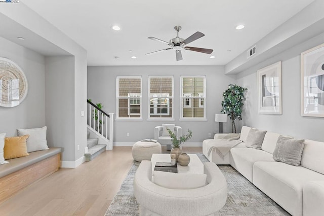 living room with ceiling fan and light wood-type flooring