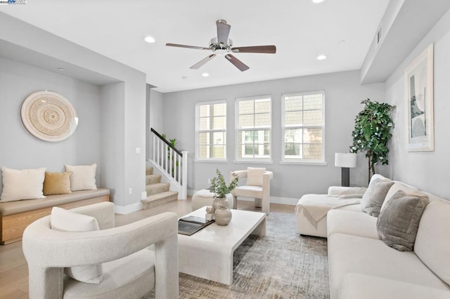 living room with ceiling fan and light wood-type flooring