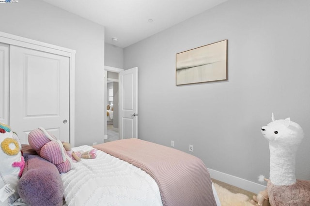 carpeted bedroom featuring a closet